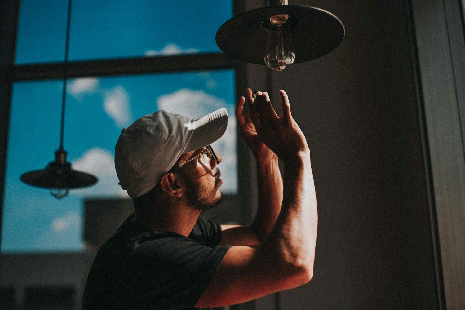 Electrician installing a ceiling light